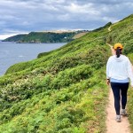 A lady walking along a coastal path