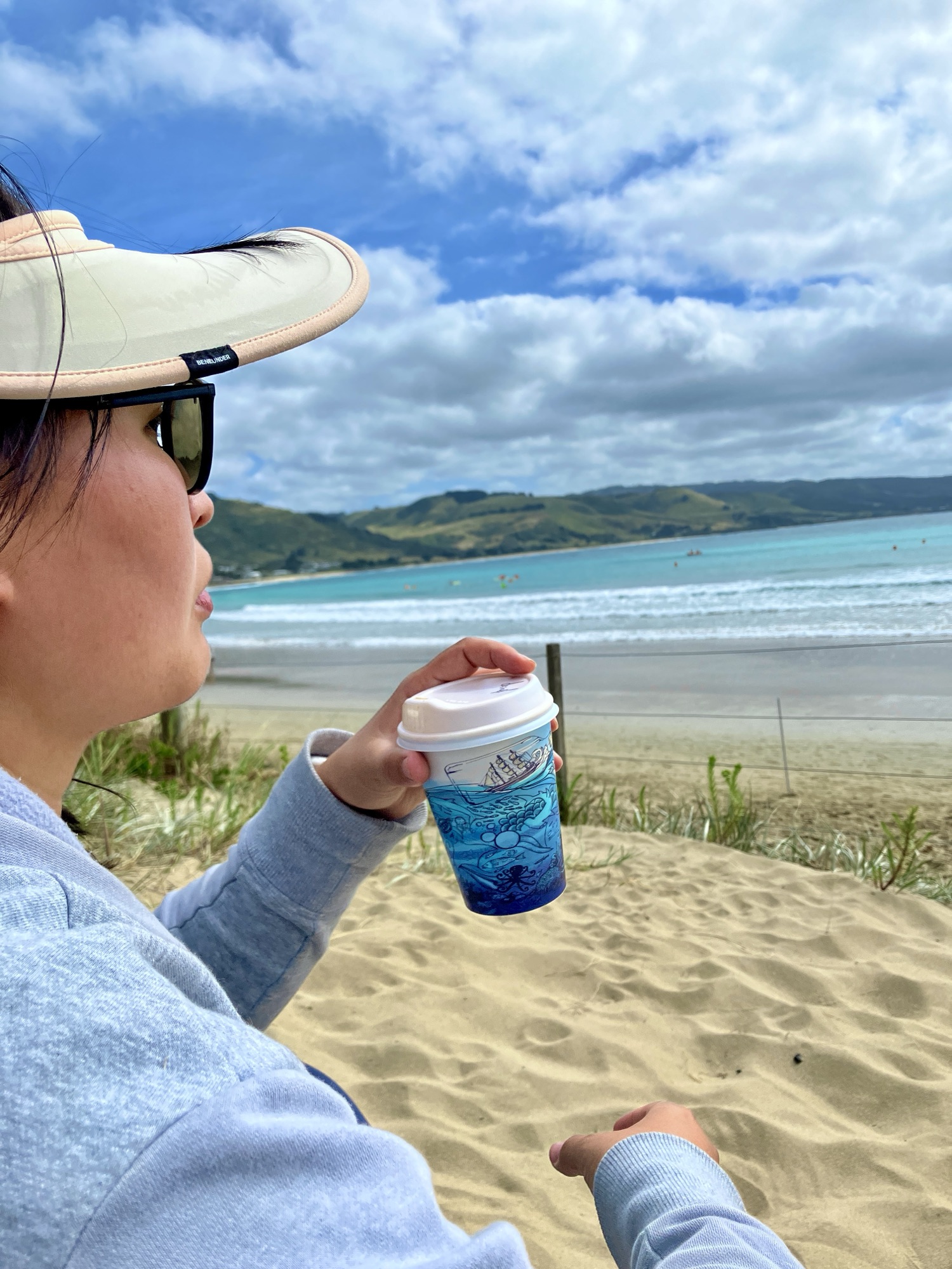 Drinking coffee beside the ocean