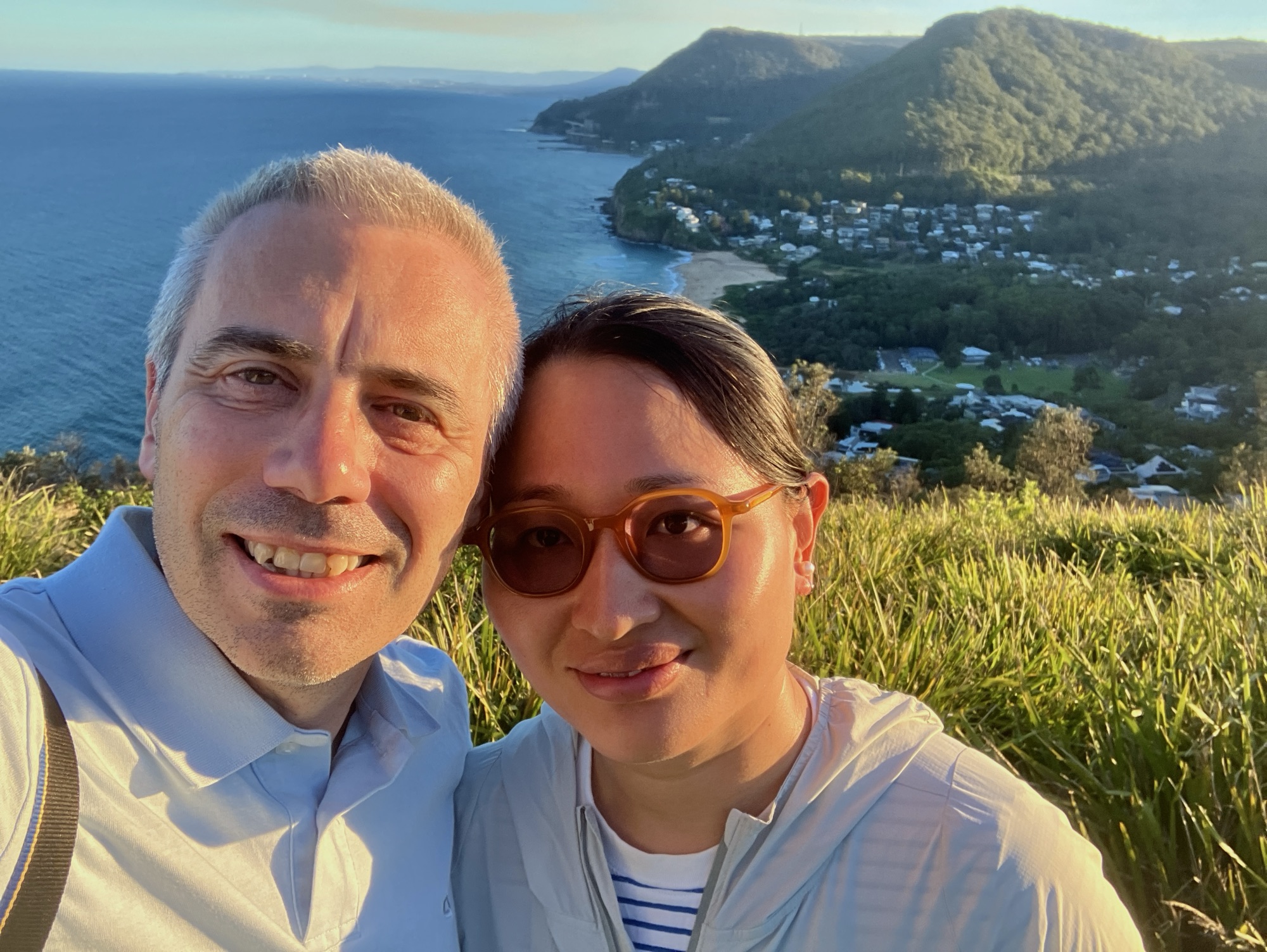 A glamorous couple overlooking coastline and hills